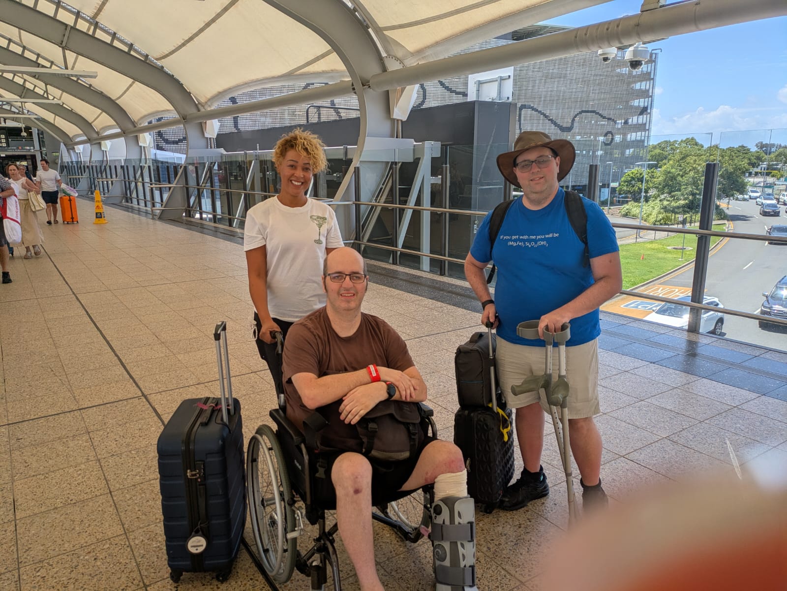 Man in wheelchair with carer at airport